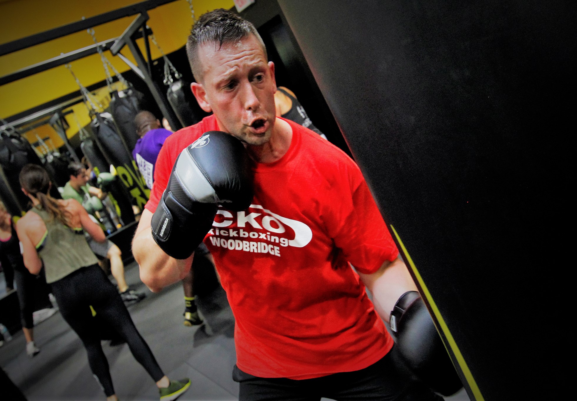 Male in red cko shirt boxing